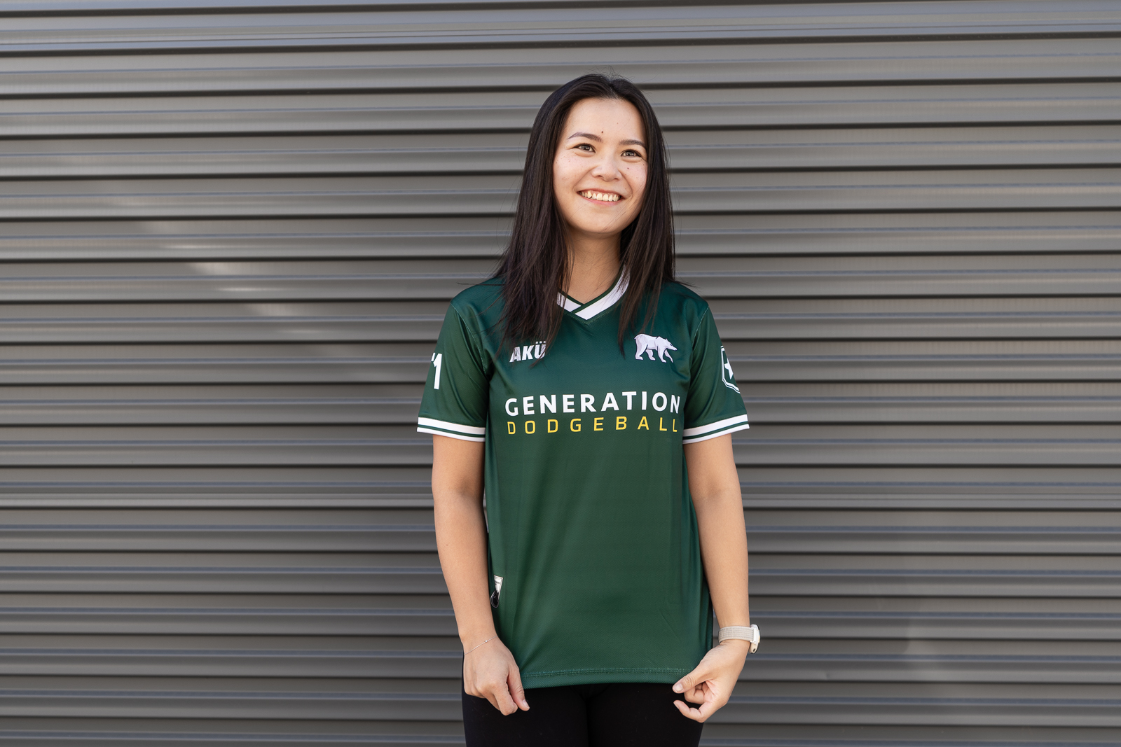 Dodgeball players with horse logo jerseys holding dodgeballs